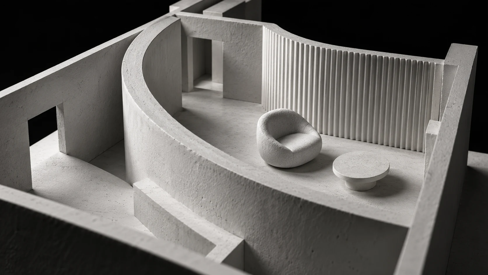 A close view of a white plaster interior model with a curved partition and sculptural furniture against black
